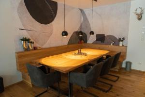 a wooden table in a room with chairs around it at New Penthouse near Sölden - Runhof Top11 in Längenfeld