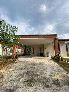 a house with a large driveway in front of it at BTS Modern Homestay Retreat in Mantin