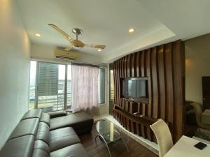 a living room with a couch and a television at WakakaPackers in Kuala Lumpur
