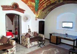 a living room with a couch and a tv at Lucky Seven in Luxor