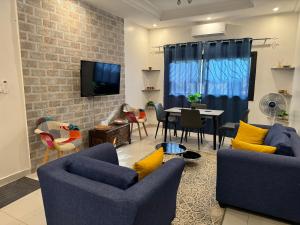 a living room with two couches and a dining room at Maison de vacance Saly in Mbour