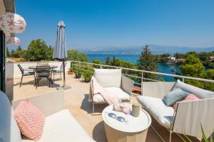 a patio with a table and chairs on a balcony at Holiday Home Dora in Splitska