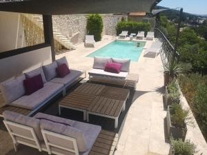 a patio with lounge chairs and a swimming pool at Plus Belle La Vue Allauch in Allauch