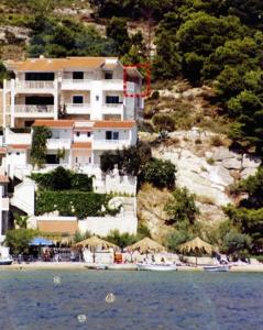 a large building on a hill next to a beach at Villa Nada in Duće