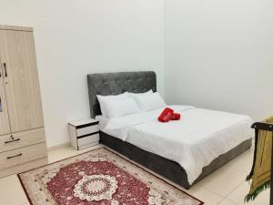 a bedroom with a bed with a red object on it at NASUHA HOMESTAY 3 TEMERLOH Semi-D House, 3 Bedroom, 2 Bathroom, 4 Unit Aircond, Free Wifi and Netflix in Temerloh