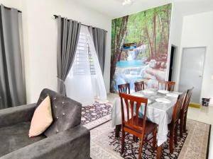 a living room with a table and a couch at NASUHA HOMESTAY 3 TEMERLOH Semi-D House, 3 Bedroom, 2 Bathroom, 4 Unit Aircond, Free Wifi and Netflix in Temerloh