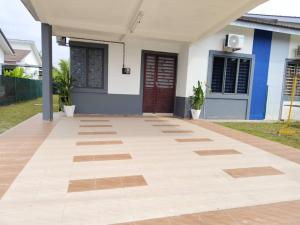 a porch of a house with a tile floor at NASUHA HOMESTAY 3 TEMERLOH Semi-D House, 3 Bedroom, 2 Bathroom, 4 Unit Aircond, Free Wifi and Netflix in Temerloh