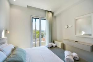 a bedroom with a bed and a large window at Villa Verde, Kobitsi Corfu in Corfu +27 photos