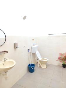 a bathroom with a toilet and a sink at NASUHA HOMESTAY 3 TEMERLOH Semi-D House, 3 Bedroom, 2 Bathroom, 4 Unit Aircond, Free Wifi and Netflix in Temerloh