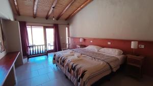 a bedroom with a large bed in a room at Pirca del Abuelo II in Purmamarca