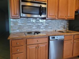 a kitchen with a stove and a microwave at Champagne Island Resort Unit 107 in Wildwood