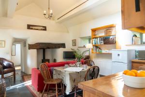 a kitchen and living room with a table and a couch at Glanrhyd cottage in Betws-y-coed +49 photos