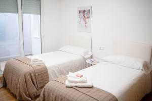 En eller flere senge i et værelse på A Cabana de Pado