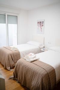 En eller flere senge i et værelse på A Cabana de Pado