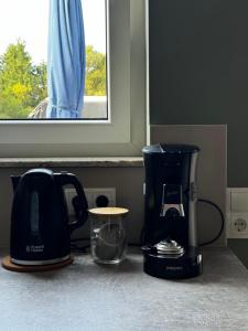 a kitchen counter with a coffee maker and a blender at Comfort Apartment - Bis 6 Schlafplätze mit 4 Betten in Raubach