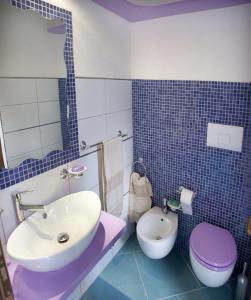 a bathroom with a sink and a toilet at Casa Vacanza Alice & Mari in Ascea