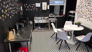 a restaurant with white chairs and a table and a sink at Digz Hotel in Middlesbrough