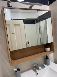 a mirror above a sink in a bathroom at ILSA Apartment in Durrës +17 photos
