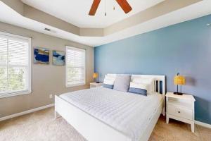 a bedroom with a white bed and two windows at Home Sweet Home in Charleston! 3BR full amenities in Charleston