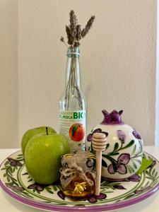 a bottle of alcohol sitting on a plate with fruit at Onar Seaview Apartment in Pythagorio in Pythagoreio +9 photos