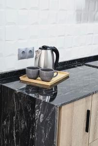 a tea kettle and two bowls on a cutting board on a counter at Vera Holydays in Torremolinos