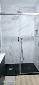 a bathroom with a shower with white marble at Vera Holydays in Torremolinos +5 photos