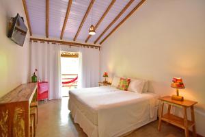 Cama ou camas em um quarto em Casa de Paixão Caraíva