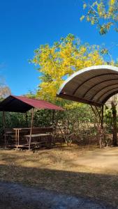 a picnic table and a pavilion in a park at Cabinas en Playas del Coco in Sardinal