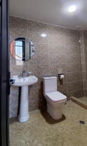 a bathroom with a toilet and a sink and a mirror at Hotel Red Tower in Zugdidi +67 photos