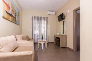 a living room with a couch and a table at Sole A Mare in Neos Marmaras