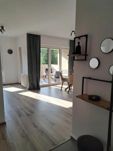 a living room with a hardwood floor and sliding glass doors at Transilvania Memories in Sighişoara