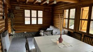 a dining room with a table in a log cabin at La Araucaria in Potrerillos +26 photos