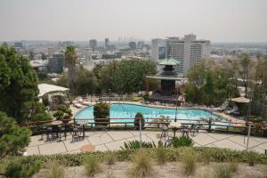 a large swimming pool with a gazebo in a city at Hollywood Hills Hotel in Los Angeles