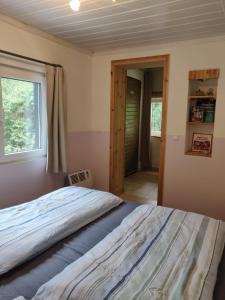 a bedroom with a large bed and a window at Ferienhaus Green Garden Berlin - Welcome to Berlin in Berlin