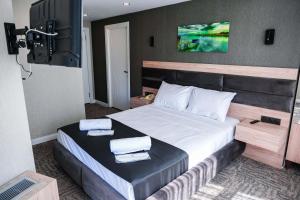 a bedroom with a large bed with two towels on it at Siwiss İnn Experess in Ankara