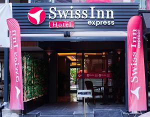 a hotel sign in front of a building at Siwiss İnn Experess in Ankara