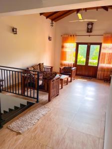 a living room with two couches and a couch at Heaven Hill Guesthouse in Weligama