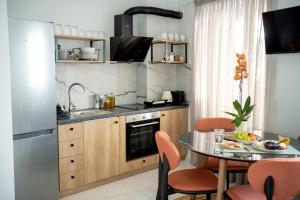 a small kitchen with a table and a sink at Eva's paradise Syros in Ermoupoli