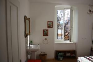 a white bathroom with a sink and a window at Villa Rosa since 1914, Brenta Dolomite in Terres