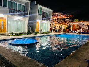 a swimming pool in front of a building at night at Villa Coco Mare Suite 1 in Coyuca