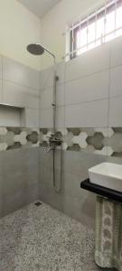 a bathroom with a shower and a sink at Tranquil Two-bed Retreat in Mahébourg +6 photos