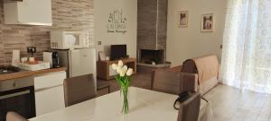 a kitchen with a table with a vase of flowers on it at Casa Vacanze "Le Tre Formiche" a Poggio Moiano in Poggio Moiano