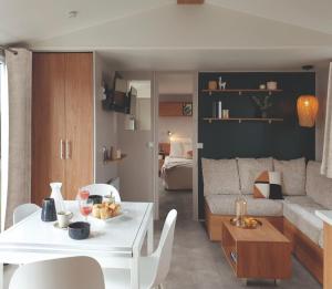 a living room with a white table and a couch at LUXURY Eden 55m2 Fun pass exclus in Canet-en-Roussillon