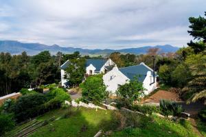 an aerial view of a house with mountains in the background at De Molen Guest House in Somerset West