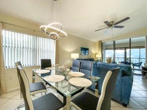 a dining room and living room with a table and chairs at Spacious Shorewalk 2B-2B Condo near Anna Maria Island, Beaches & IMG Academy in Bradenton