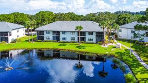 an aerial view of a house with a pond at Spacious Shorewalk 2B-2B Condo near Anna Maria Island, Beaches & IMG Academy in Bradenton
