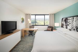 a hotel room with a bed and a television at Sheraton Miami Airport Hotel and Executive Meeting Center in Miami