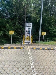 a gas pump sitting on the side of a road at Fabulous Panorama Silver Mountain Apartments in Poiana Brasov
