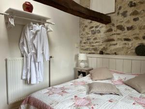 a bedroom with a bed and a towel hanging on a wall at Maison Du Silence in Saint-Maurice-près-Pionsat
