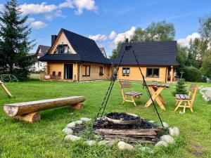 a house with a fire pit in front of it at Miło Zakopane in Zakopane